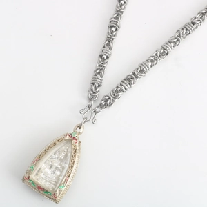 Detailed view of silver woven dragon chain necklace with an ornate Buddha pendant