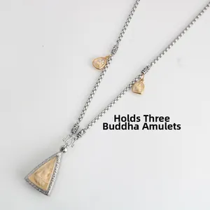 Macro detail of vintage stainless steel box chain necklace designed to hang 3 amulets