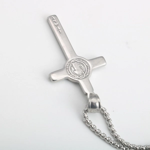 Macro view of vintage stainless steel St. Benedict cross pendant with detailed box chain