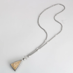 Detail of silver snake chain with intricately carved triangular Buddha pendant