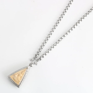 Close-up of stainless steel Thai Buddha pendant necklace with retro engraved details