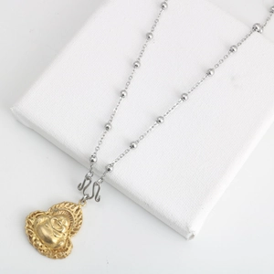 Detailed view of a golden Maitreya Buddha pendant with a silver-tone beaded steel chain