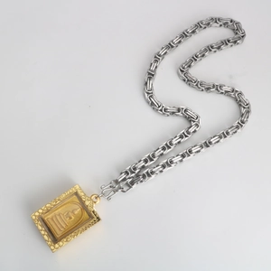 Detail showing gold rectangular Buddha pendant and silver Byzantine stainless steel chain