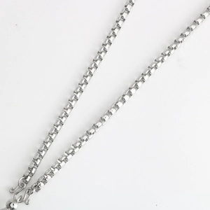 Detail of silver box chain with S-hook clasp made of polished stainless steel
