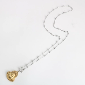 Detail of a two-tone round bead chain with a gold heart-shaped Maitreya Buddha pendant