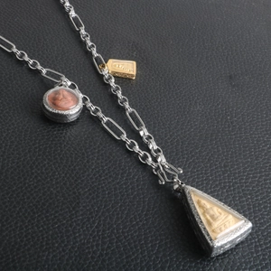 Detailed view of silver stainless steel religious necklace with multiple Buddha pendants