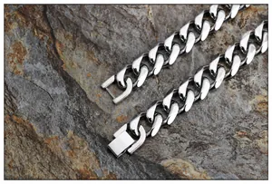 Macro view of polished silver stainless steel Cuban link chain with secure buckle closure