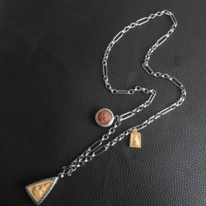 Detailed view of stainless steel Buddhist pendant necklace with ornate mixed link chain