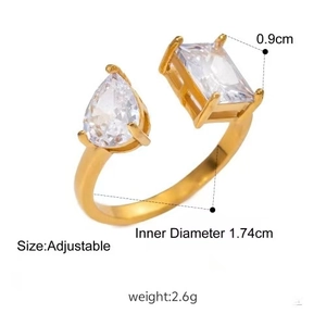 Detailed view of adjustable golden ring with teardrop and rectangular zircon stones