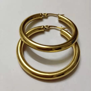 Close-up of set of two pairs of golden 4mm hollow tube hoop earrings with snap closure