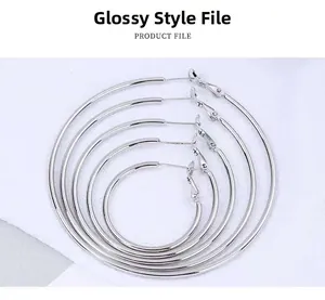 Detail view of five different sizes of minimalist smooth silver hoop earrings set