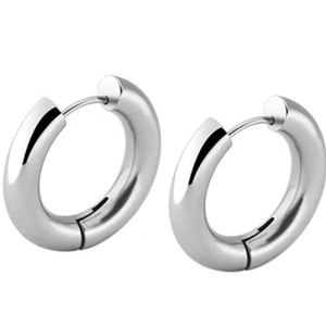 Macro shot of silver chunky hoop earrings featuring high-polish mirror finish and latch back