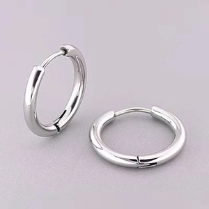 Polished silver stainless steel hoop earrings with 2.5mm thickness on a textured background