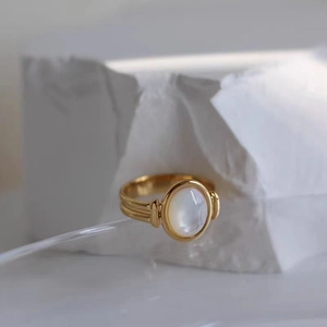 Vintage 18K gold plated titanium ring with oval white shell inlay and ribbed band details