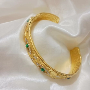 Detail of 18k gold plated cuff bracelet with green malachite and sparkling crystals