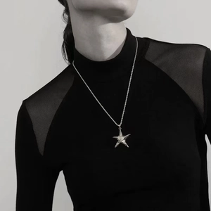 Silver starfish pendant necklace with twist rope chain shown on a model with black top