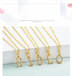 Detail of gold alphabet pendant necklace featuring sparkling zircon stones on a fine chain