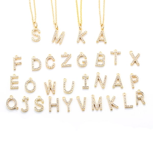 Detail view of gold alphabet pendant set with sparkling zircons on fine chain necklace