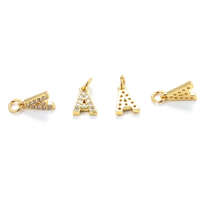 Close-up of golden letter A charms with sparkling zircon pavé and hollow back details