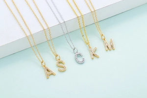 Close-up of sparkling micro-paved zircon alphabet pendants on elegant link chains
