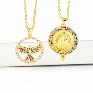 Close-up of 18K gold plated necklaces featuring colorful zircon bird and religious charms