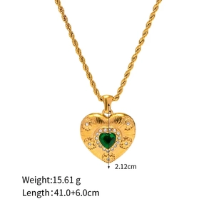 Detail view of a gold heart pendant necklace featuring a green gemstone and dimensions
