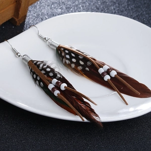 Bohemian long feather earrings with brown spotted feathers and beaded tassel details