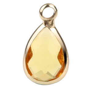 Close-up of faceted yellow teardrop gemstone pendant with a golden metal frame