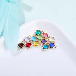 Macro shot of colorful round crystal pendants with gold metal frames for DIY jewelry