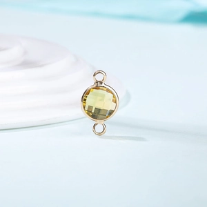 Macro shot of yellow faceted crystal pendant with gold plating and double connectors