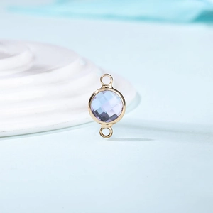 Detail of round lavender crystal birthstone connector charm with gold plated frame