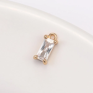 Macro view of rectangular clear crystal glass pendant with gold-plated claw setting