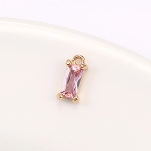 Close-up of pink rectangular crystal pendant with gold claw setting for DIY jewelry