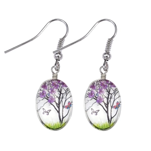 Detail of Bohemian oval drop earrings featuring a purple tree and butterfly glass pendant
