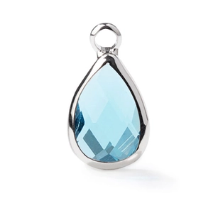 Detail of light blue faceted teardrop crystal pendant with silver metal bezel setting