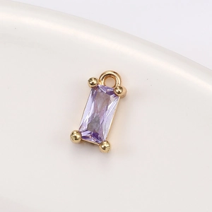 Macro view of purple step-cut crystal pendant with gold-plated decorative claw setting