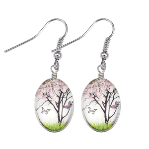 Bohemian silver drop earrings featuring oval glass charms with cherry tree and butterfly