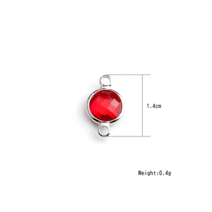 Macro shot of 1.4cm red round faceted birthstone crystal pendant with silver dual loops
