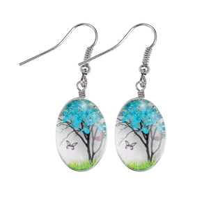 Detail of bohemian glass earring featuring a miniature blue flower tree and butterfly