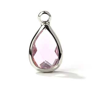 Macro shot of a faceted teardrop pink glass pendant with a polished silver-colored frame
