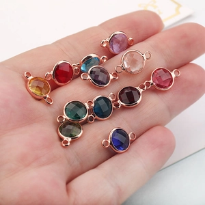 Close-up of colorful faceted birthstone crystal charms in palm for DIY jewelry making