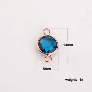 Macro detail of 8mm dark blue crystal connector in rose gold setting with measurements
