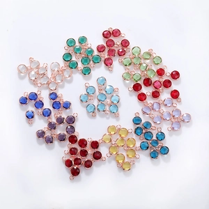 Macro view of multi-colored 6mm faceted birthstone charms with rose gold metal connectors