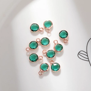 Detail of 6mm green birthstone charms with rose gold copper plating for DIY jewelry making