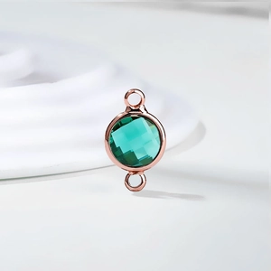 Close-up of rose gold emerald crystal birthstone connector for DIY jewelry making