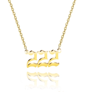 Close-up of golden number 222 pendant necklace with Gothic style font detail