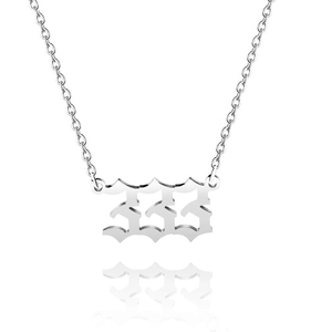 Detail shot of silver angel number 333 pendant necklace with stylish gothic numbers