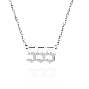 Macro shot of silver stainless steel necklace featuring a vintage 555 angel number pendant