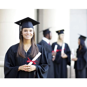 Classic black graduation gown set with cap and diploma scroll on campus background