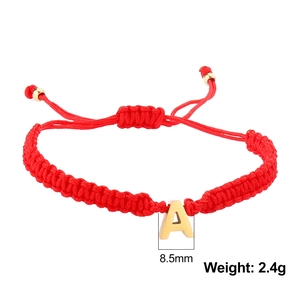 Detail of red braided cord bracelet with gold letter A charm and 8.5mm size specs